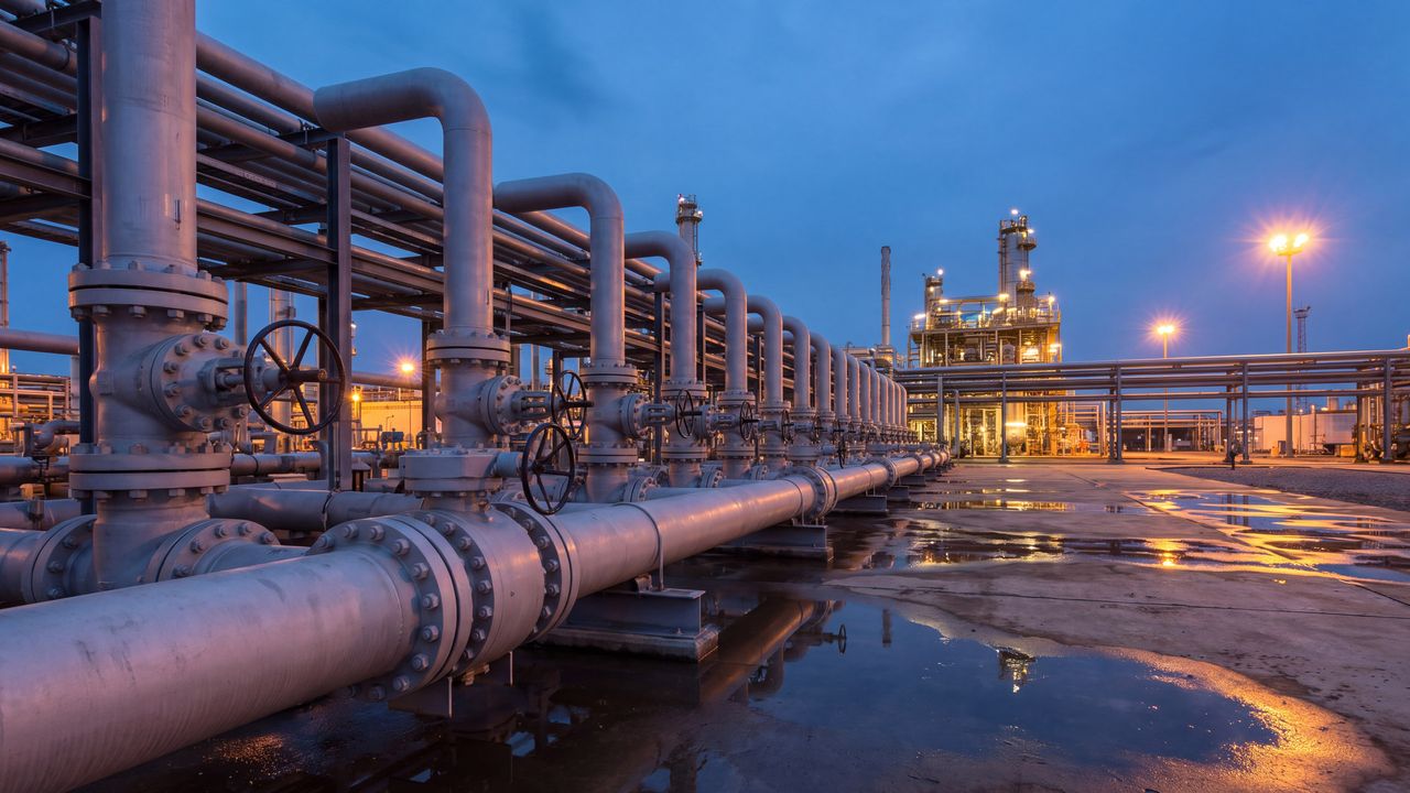 Pipes and valves of a distribution facility at dusk